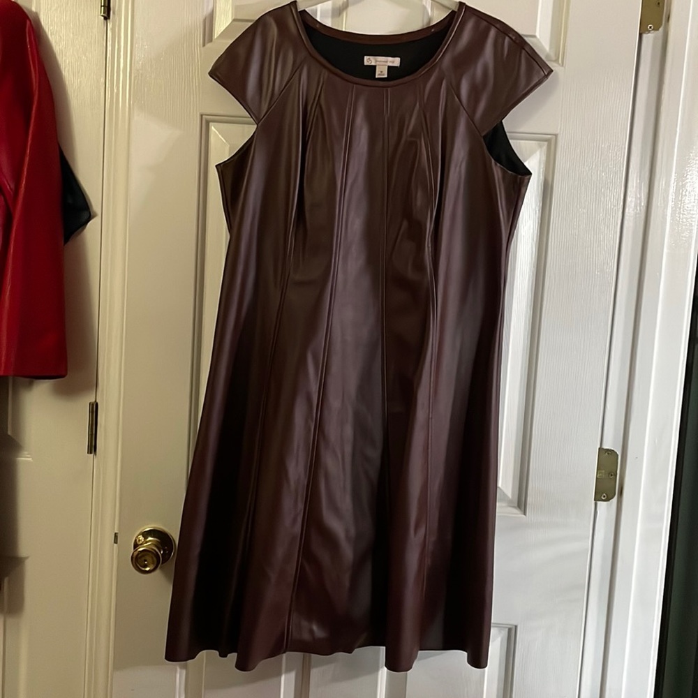 Size 16 brown leather look dress. 100% polyurethane face with polyester back.